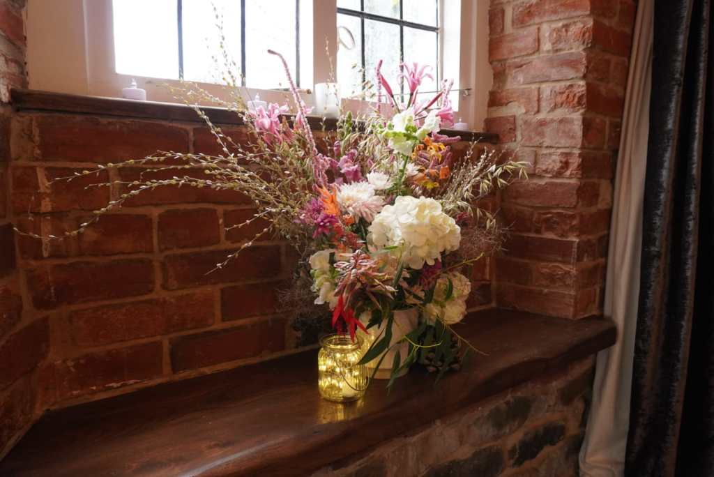 Dried flower arrangement for a wedding window display, with whites and pinks