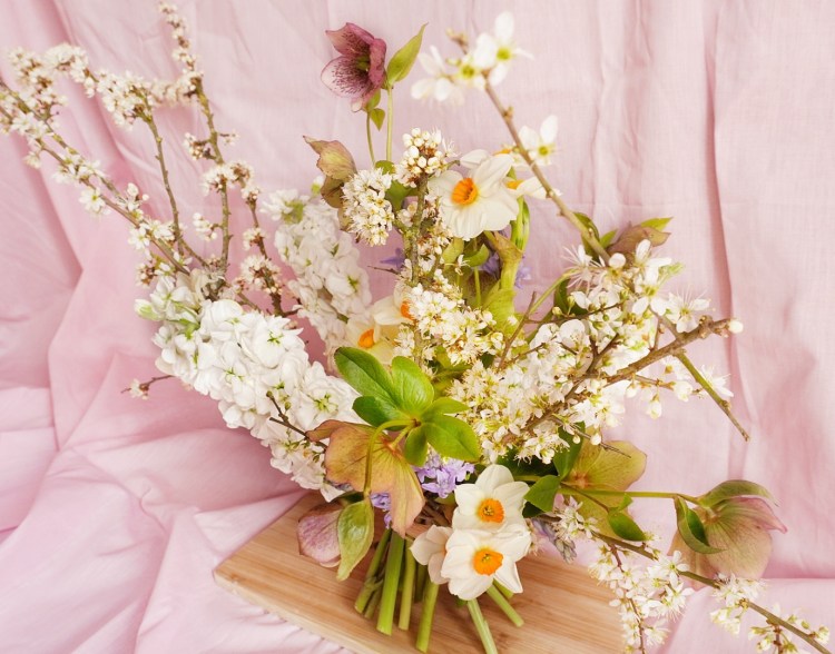 Bouquet of British spring flowers with cherry tree branches, narcissi, hellebores, stocks