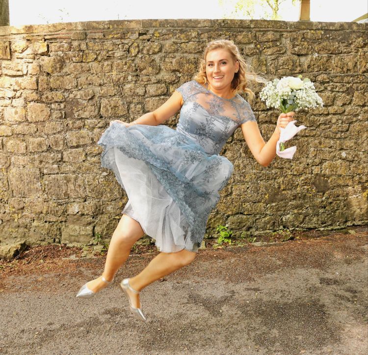 Bridesmaid in blue lace dress with bouquet