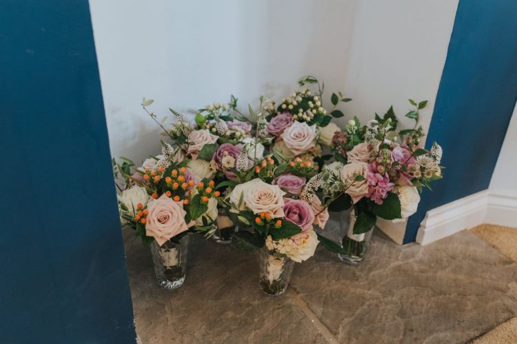 Bouquets in vases, of whimsical garden style in pinks and whites