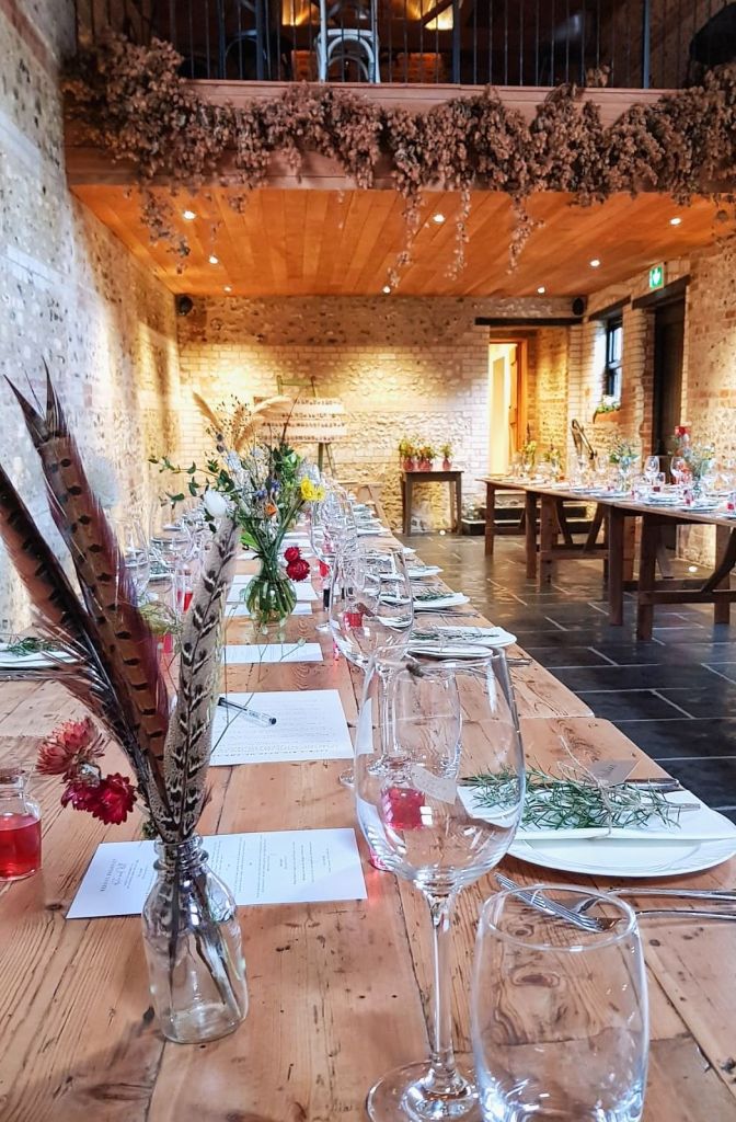 Table budvases with fresh and dried flowers and pheasant feathers