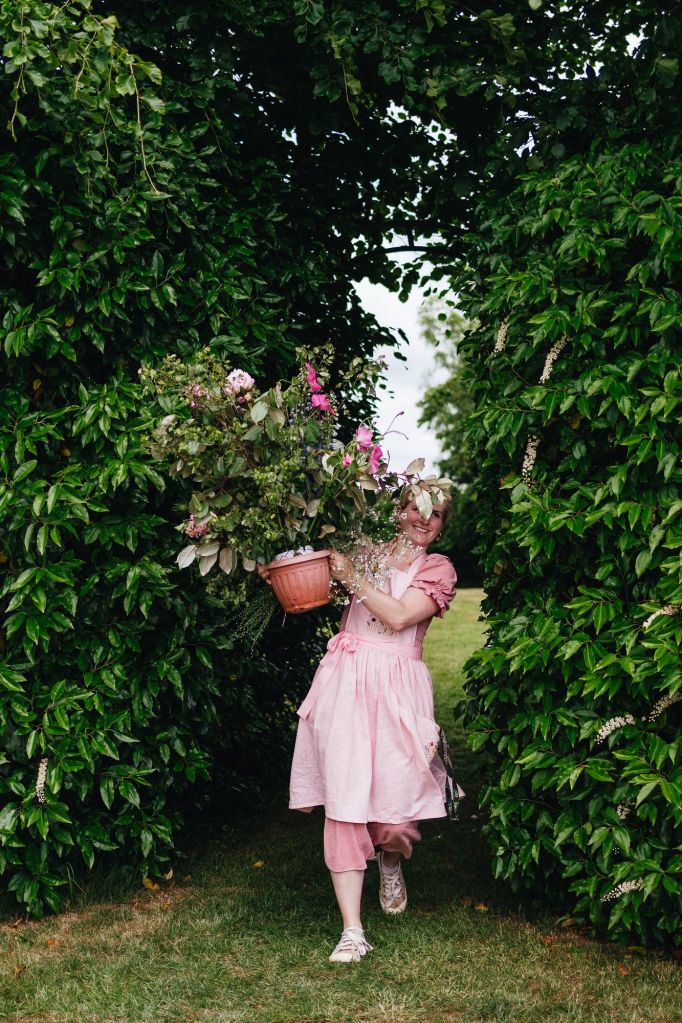 Florist The Honey Seeker Floral Design setting up at festival themed wedding venue Pennard Hill Farm near Glastonbury Festival in Somerset