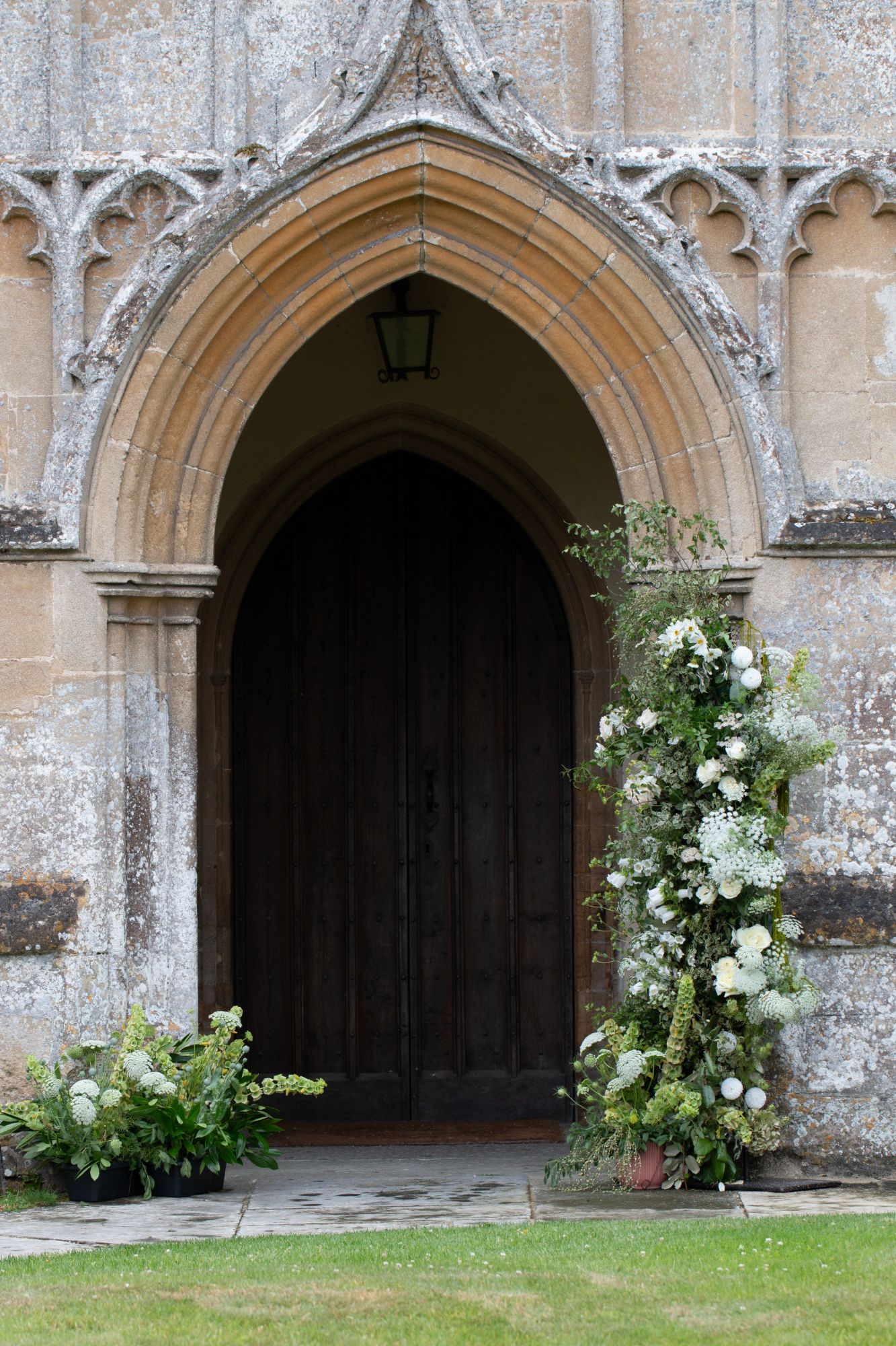 Grand church wedding at North Cadbury Court, Somerset with floral arch by The Honey Seeker Floral Design