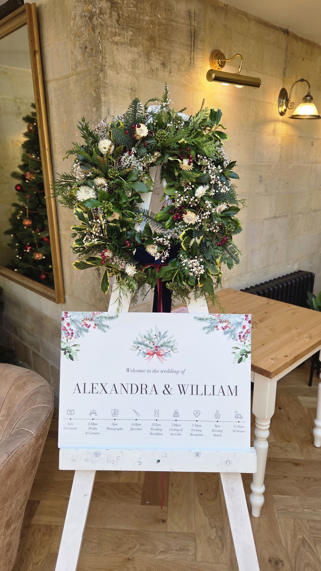 Christmas wreath to represent Christmas wedding and also Greek Wreath's signifying where the couple got engaged. Flowers by The Honey Seeker Floral Design at The Moonraker Hotel in Wiltshire.