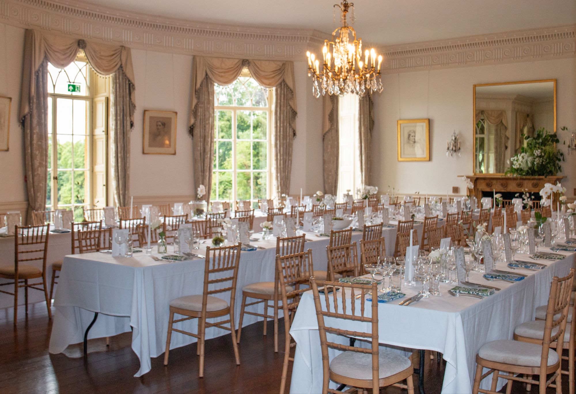 The ballroom at North Cadbury Court, with M shape table arrangements and bud vase flowers by The Honey Seeker Floral Design