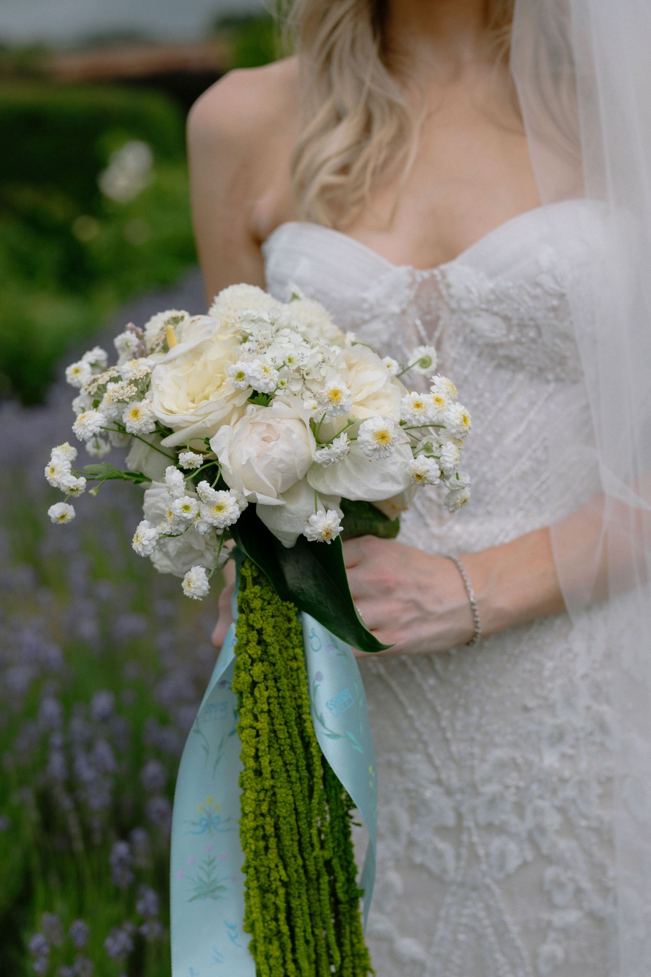 Bride holding her bouquet, by The Honey Seeker Floral Design, at North Cadbury Court, photo: Sophia Veres