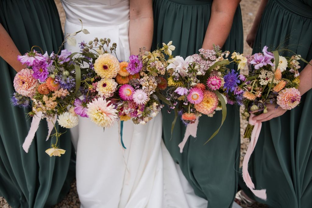 Bridal and bridesmaids bouquets, summer jewel tones, at wedding venue Folly Farm Centre in Bristol, flowers by The Honey Seeker Floral Design