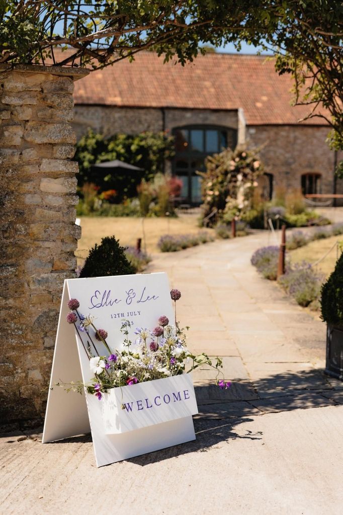 Welcome sign florals by The Honey Seeker Floral Design at wedding venue Priston Mill in Bath