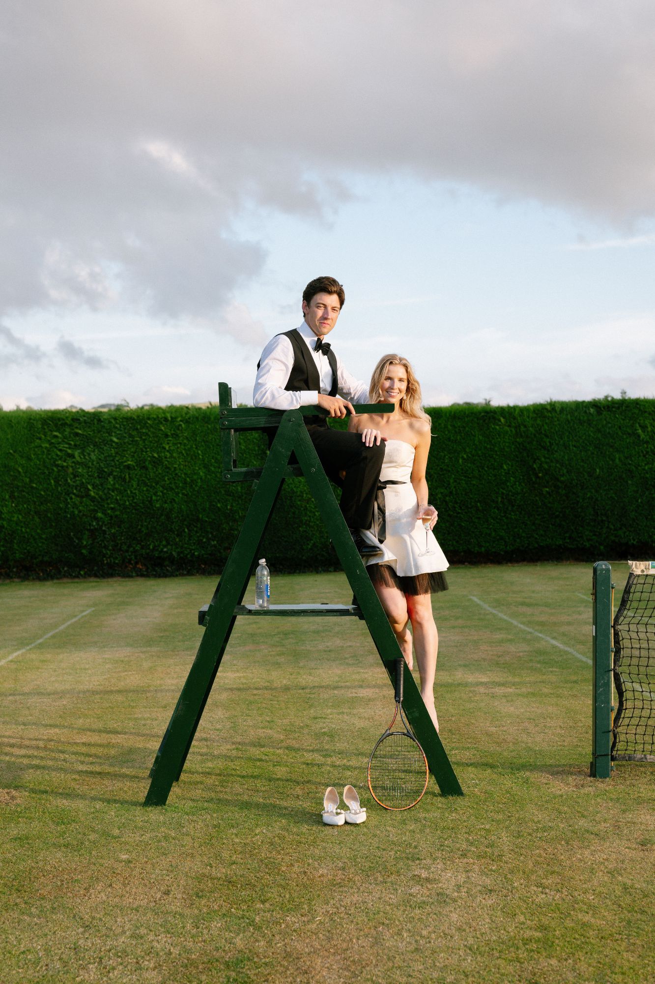 Bride and Groom playing a game of tennis at North Cadbury Court after the ceremony