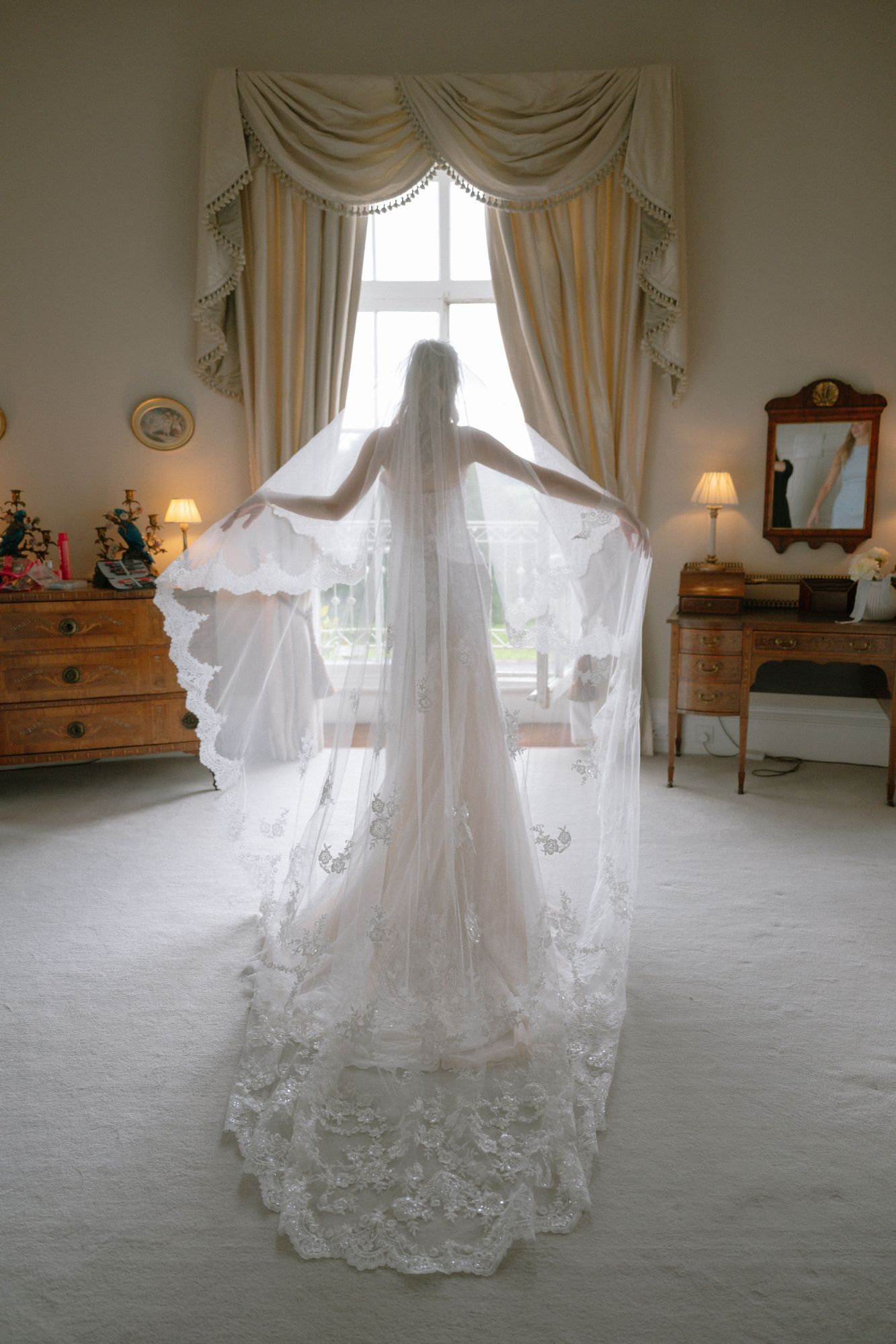 Bride standing in the Bridal Suite at North Cadbury Court, photo: Sophia Veres