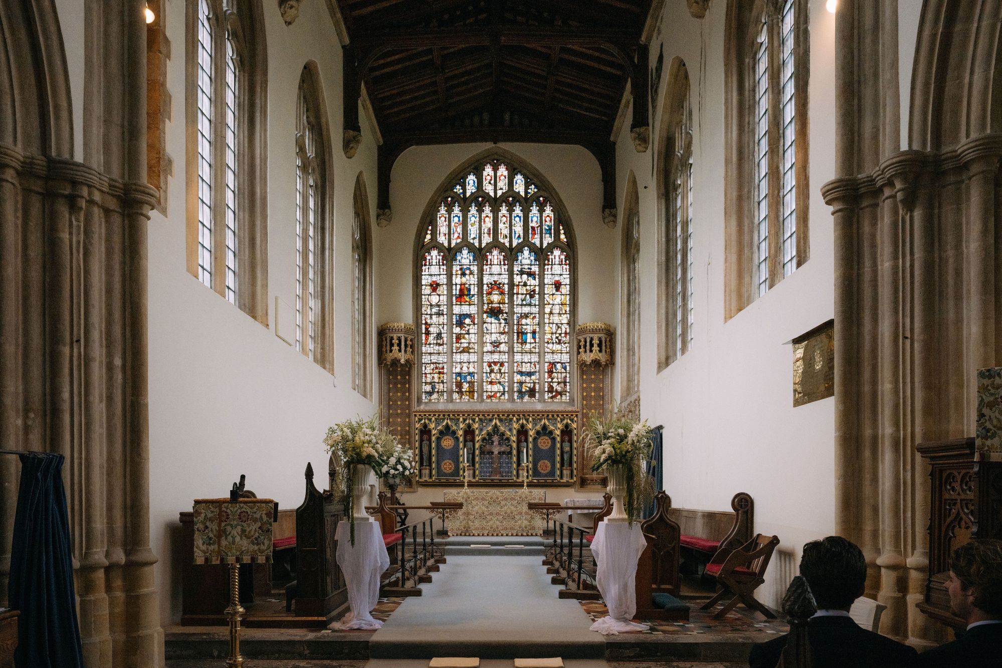 St. Michael's church at North Cadbury Court, waiting with urn flowers for the ceremony, by The Honey Seeker Floral Design in Somerset