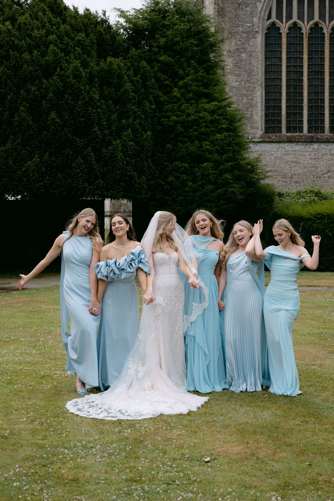 Bride and her bridemaidsd, posing for a photo, outside North Cadbury Court, photo: Sophia Veres
