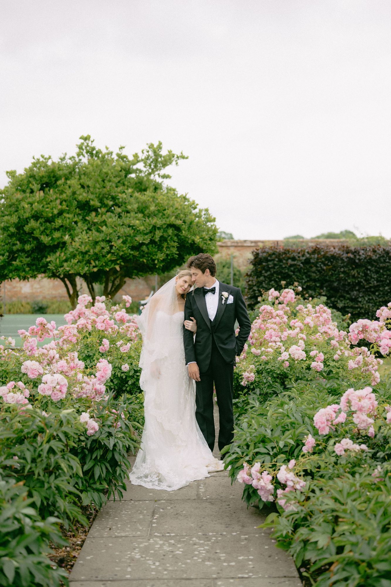 Bride and Groom in the roses at North Cadbury Court