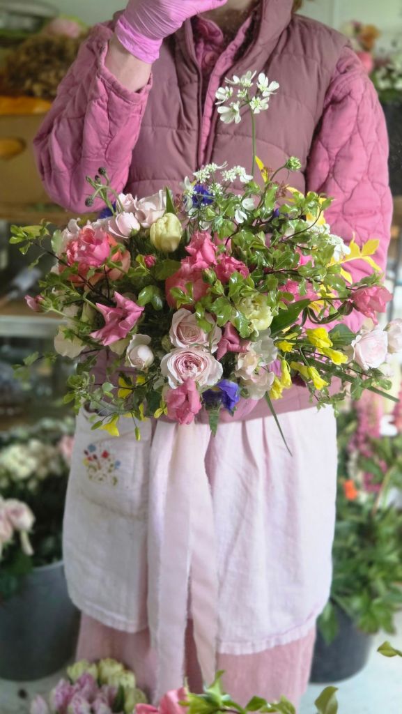 Gorgeous spring bridal bouquet full of sweet peas, ranunculus and roses