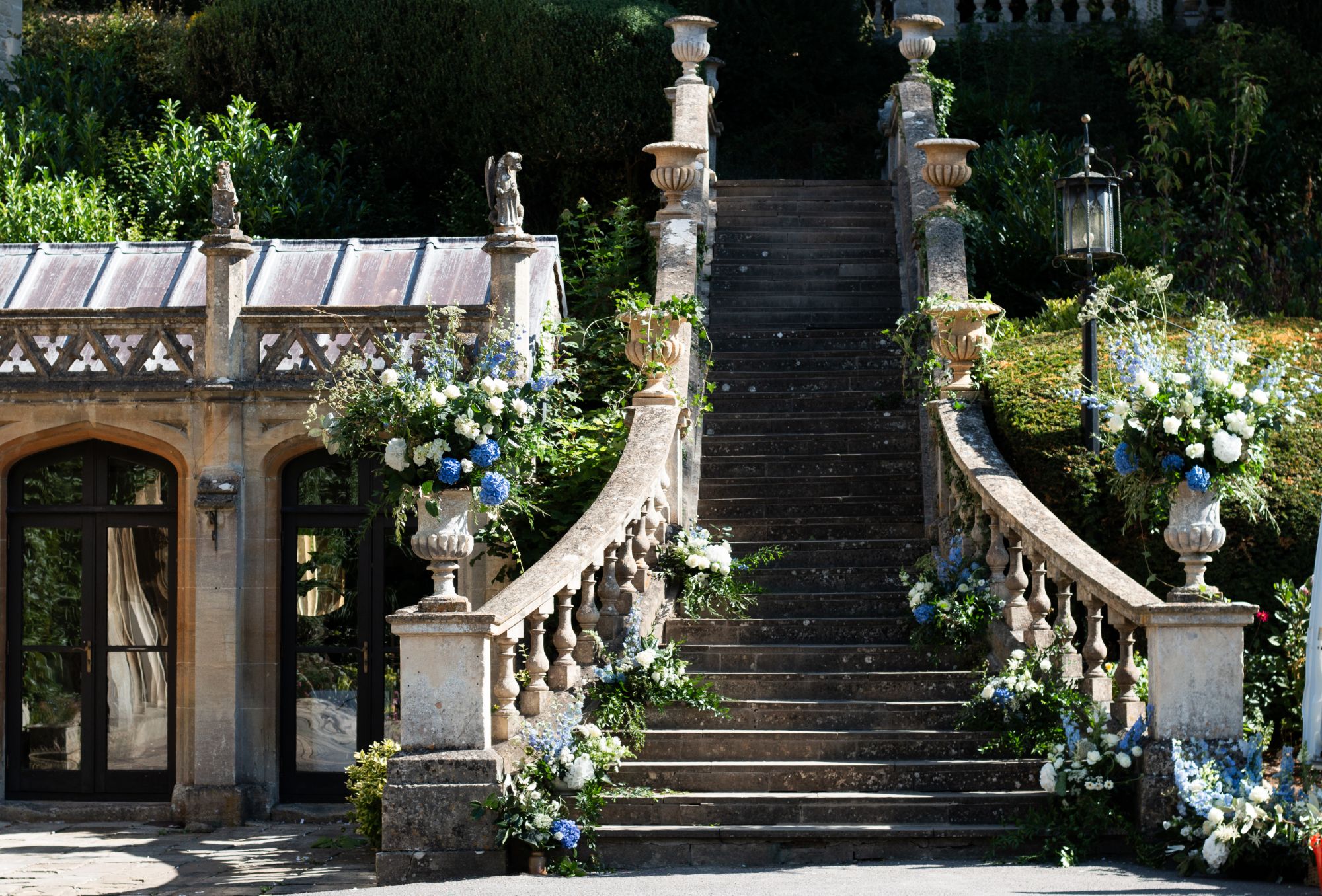 Huge urn floral arrangements at The Manor House in Castle Combe. Photo by Orinta Fowler Photography