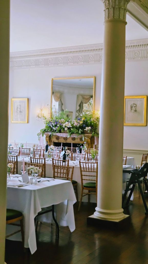 Mantelpiece covered in wedding flowers at North Cadbury Court in Somerset